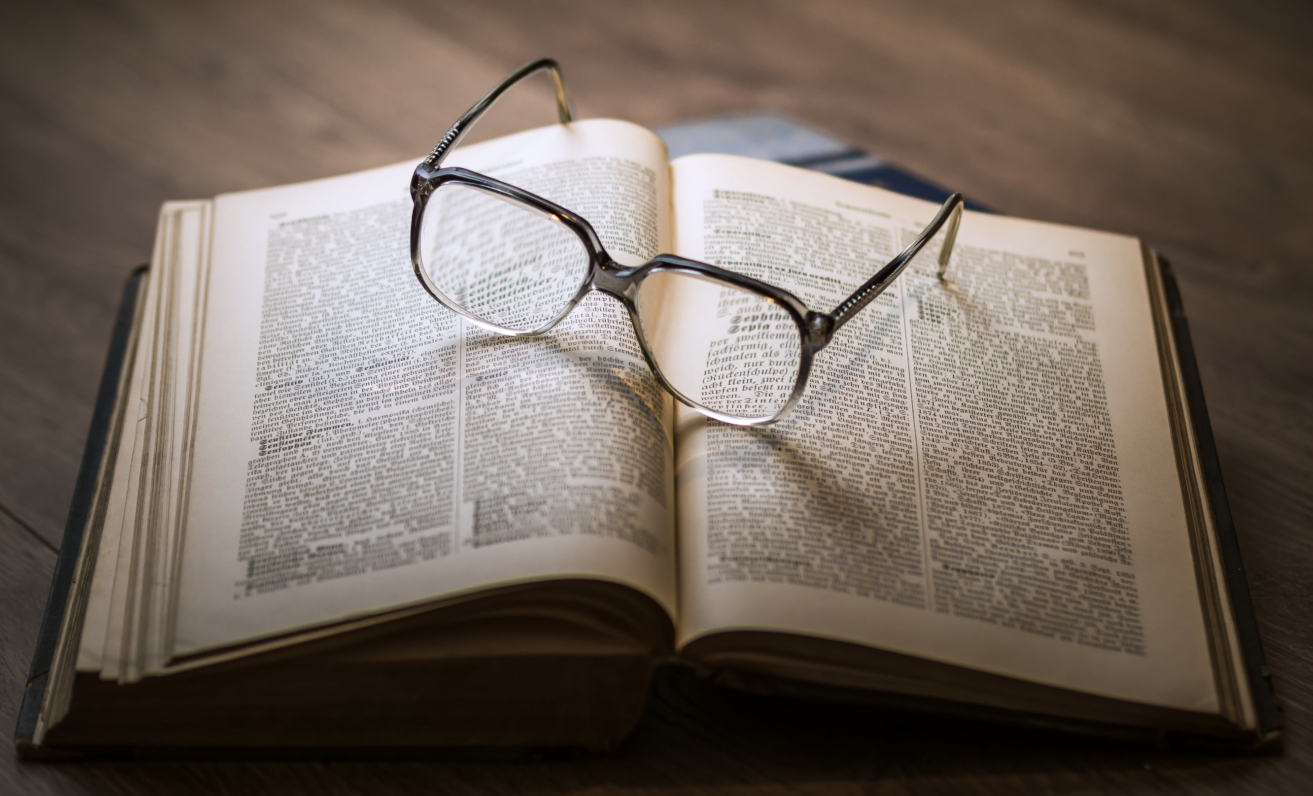 open book with glasses on top